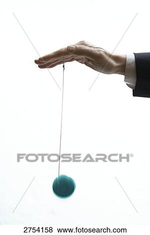 Stock Photo - Close-up of person playing with yo-yo . Fotosearch