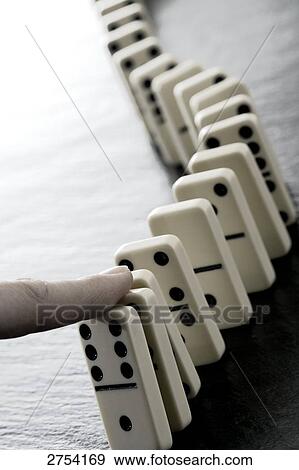 Stock Photo - Close-up of person's finger and dominos . Fotosearch