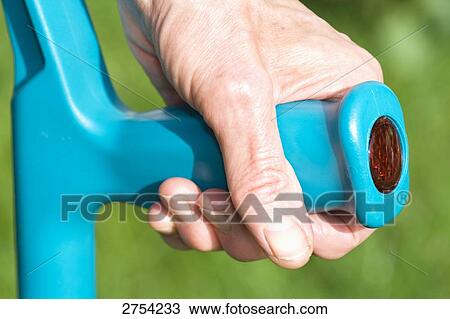 Close-up of person's hand holding crutch View Large Photo Image Stock Image - Close-up of person's hand holding crutch . Fotosearch