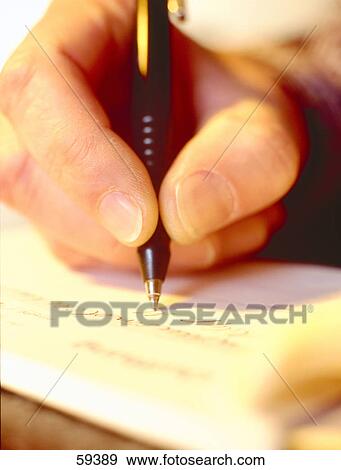 Close-up of person's hand writing with ballpoint pen View Large Photo Image Stock Photo - Close-up of person's hand writing with ballpoint pen . Fotosearch