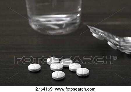 Close-up of pills and glass of water View Large Photo Image Stock Photo - Close-up of pills and glass of water . Fotosearch