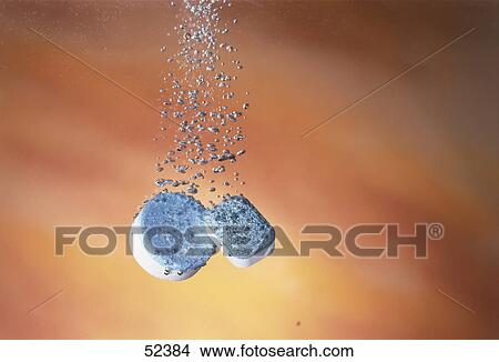 Close-up of pills fizzing in water View Large Photo Image Picture - Close-up of pills fizzing in water . Fotosearch