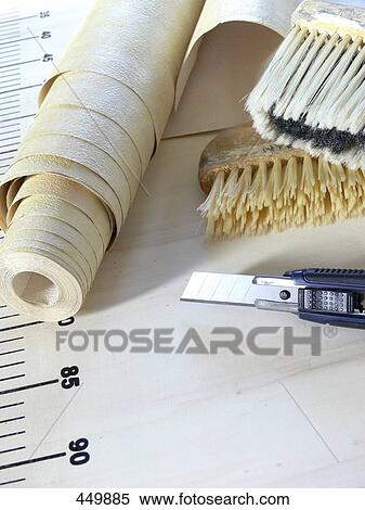 Stock Photography - Close-up of roll of wallpaper with material to put it up . Fotosearch