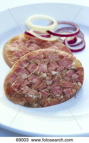 Stock Image - Close-up of salami and onion rings on plate . Fotosearch