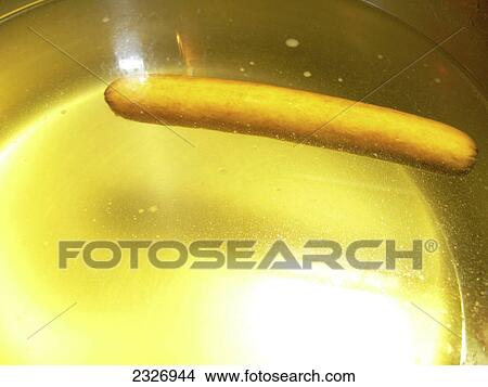 Picture - Close-up of sausage and oil in pan . Fotosearch