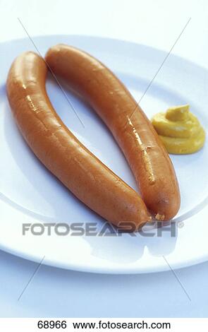 Stock Photograph - Close-up of sausages and mustard sauce on plate . Fotosearch