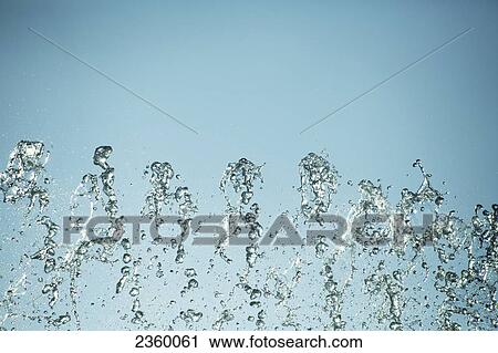 Stock Image - Close-up of splashed water droplets . Fotosearch