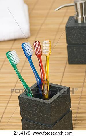 Stock Photo - Close-up of toothbrushes in holder . Fotosearch