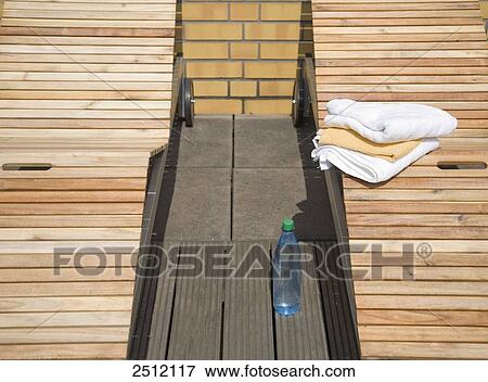 Close-up of towels on deck chair View Large Photo Image Stock Photo - Close-up of towels on deck chair . Fotosearch