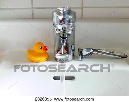 Close-up of water flowing out of faucet View Large Photo Image Stock Photography - Close-up of water flowing out of faucet . Fotosearch