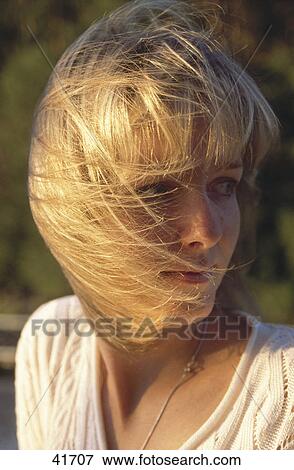 Close-up of young woman with her hair on her face View Large Photo Image Stock Photo - Close-up of young woman with her hair on her face . Fotosearch