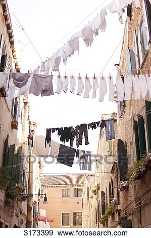 Clotheslines hanging over alley, Venice, Italy, view from below  View Large Photo Image Stock Photo - Clotheslines hanging over alley, Venice, Italy, view from below . Fotosearch
