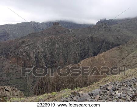 Stock Photo - Clouds over mountain range, La Gomera, Canary Islands, Spain . Fotosearch