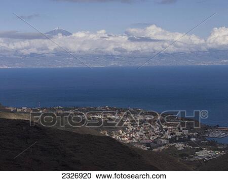 Stock Image - Clouds over town at coast, Tenerife, Canary Islands, Spain . Fotosearch