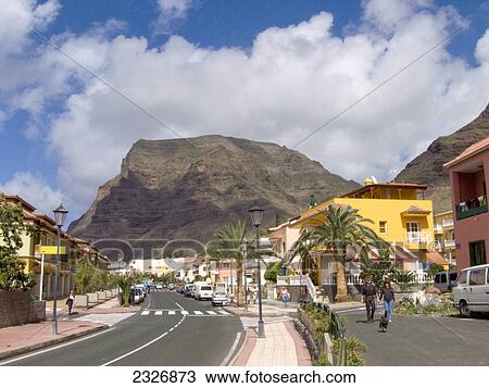 Couple walking holding hands with dog near road, Valle Grain Rey, La Gomera, Canary Islands, Spain View Large Photo Image Stock Image - Couple walking holding hands with dog near road, Valle Grain Rey, La Gomera, Canary Islands, Spain . Fotosearch