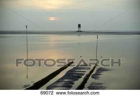 Stock Image - Dusk clouds reflected in lake water, Hamburg, Germany . Fotosearch