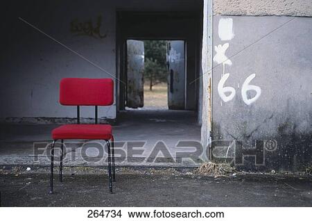 Picture - Empty chair in front of house . Fotosearch