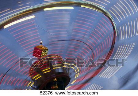 Ferris wheel in motion at amusement park View Large Photo Image Stock Photograph - Ferris wheel in motion at amusement park . Fotosearch