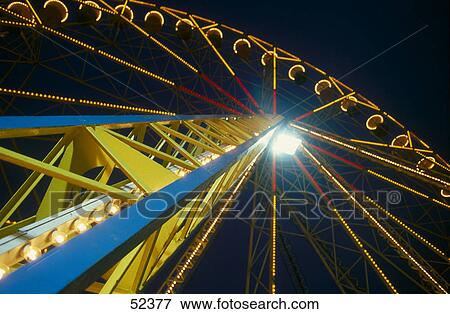 Ferris wheel lit up at night View Large Photo Image Stock Photo - Ferris wheel lit up at night . Fotosearch