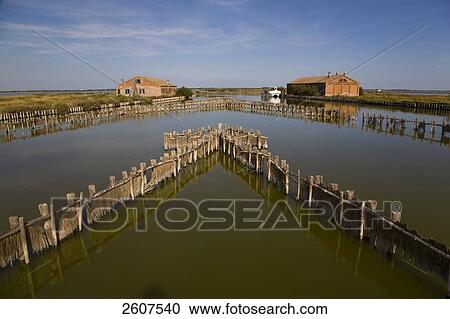Stock Image - Fish traps in river, Valli Di Comacchio, Emilia-Romagna, Italy . Fotosearch