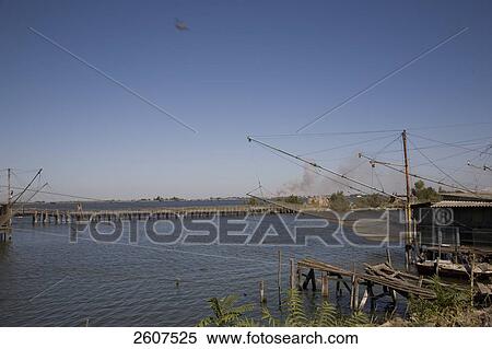 Fishing net along canal, Tagliata Canal, Cesenatico, Emilia-Romagna, Italy View Large Photo Image Stock Photography - Fishing net along canal, Tagliata Canal, Cesenatico, Emilia-Romagna, Italy . Fotosearch