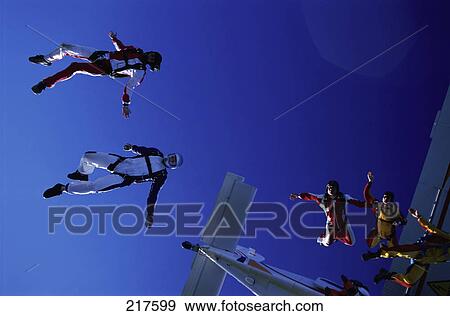 Five men diving from airplane View Large Photo Image Stock Photo - Five men diving from airplane . Fotosearch