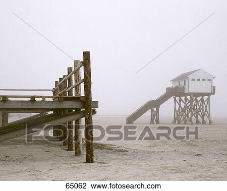 Fog over jetty and lifeguard hut on beach View Large Photo Image Stock Image - Fog over jetty and lifeguard hut on beach . Fotosearch