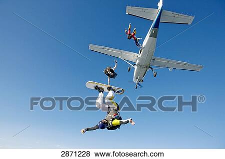 Stock Photo - Four parachutists jumping out of propeller plane, Switzerland . Fotosearch