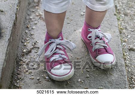 Stock Photography - Girl with children's shoes, lower section . Fotosearch