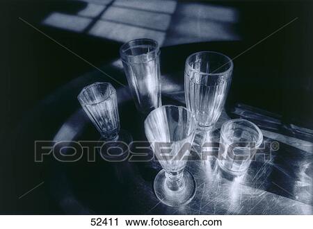 Stock Image - Glasses on table . Fotosearch