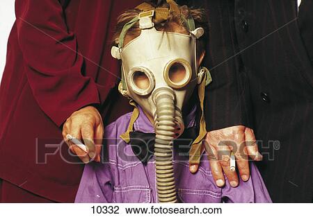 Hands of two adults holding cigarette on the shoulder of a child wearing a gas mask View Large Photo Image Stock Image - Hands of two adults holding cigarette on the shoulder of a child wearing a gas mask . Fotosearch
