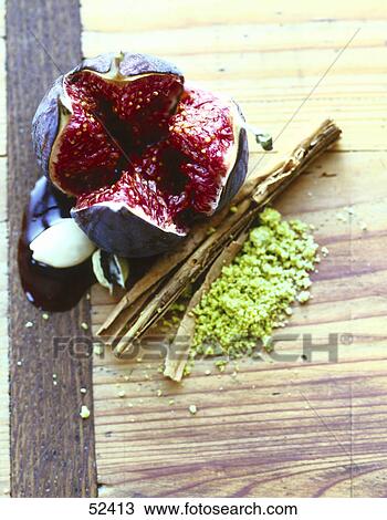 Stock Image - High angle view of a fresh fig with cinnamon and pistachio . Fotosearch