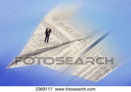 High angle view of figurine of businessman standing on paper airplane View Large Photo Image Stock Photo - High angle view of figurine of businessman standing on paper airplane . Fotosearch