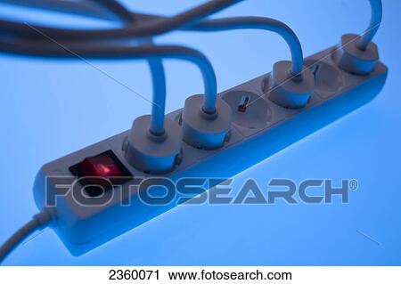 Stock Image - High angle view of gang socket full of electric plugs . Fotosearch