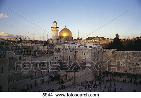 Picture - High angle view of old sacred wall with mosque in background, Wailing Wall, Dome Of The Rock, Jerusalem, Israel . Fotosearch