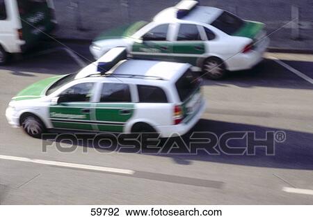 Stock Image - High angle view of police cars on road . Fotosearch