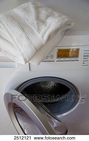 Stock Image - High angle view of towel on washing machine . Fotosearch