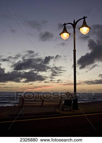Lamppost lit up at coast during dusk, Valle Grain Rey, La Gomera, Canary Islands, Spain View Large Photo Image Stock Image - Lamppost lit up at coast during dusk, Valle Grain Rey, La Gomera, Canary Islands, Spain . Fotosearch