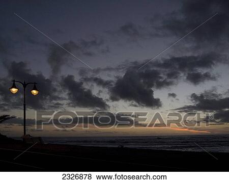 Stock Photo - Lamppost lit up at coast during dusk, Valle Grain Rey, La Gomera, Canary Islands, Spain . Fotosearch
