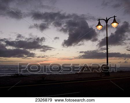 Stock Photo - Lamppost lit up at coast during dusk, Valle Grain Rey, La Gomera, Canary Islands, Spain . Fotosearch