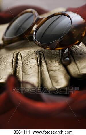 Stock Image - Leather glove and sunglasses, close-up . Fotosearch