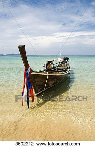 Longtail boat on the beach of Ko Muk, Thailand View Large Photo Image Stock Image - Longtail boat on the beach of Ko Muk, Thailand . Fotosearch