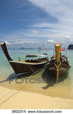 Longtail boats on the beach, Ko Ngai Island, Thailand View Large Photo Image Picture - Longtail boats on the beach, Ko Ngai Island, Thailand . Fotosearch