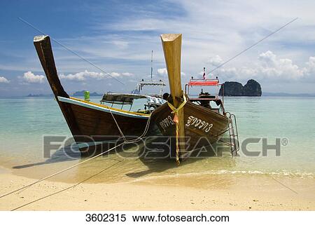 Stock Photography - Longtail boats on the beach, Ko Ngai Island, Thailand . Fotosearch