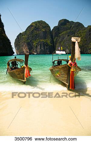 Stock Photograph - Longtail boats on the beach, Ko Phi Phi, Thailand . Fotosearch