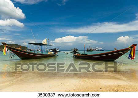 Longtail boats on the beach, Ko Phangan, Thailand View Large Photo Image Stock Photo - Longtail boats on the beach, Ko Phangan, Thailand . Fotosearch