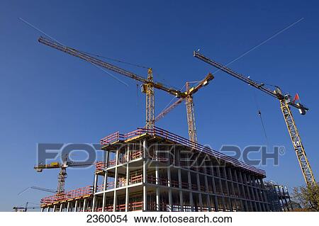 Low angle view of cranes at construction site View Large Photo Image Picture - Low angle view of cranes at construction site . Fotosearch