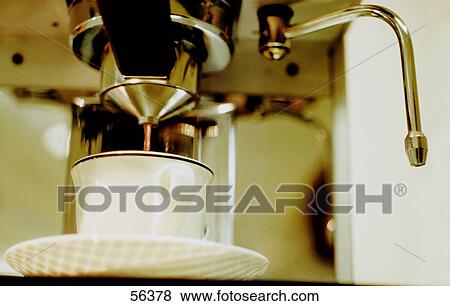 Stock Photo - Low angle view of espresso maker and coffee cup . Fotosearch