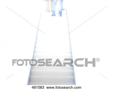 Stock Image - Low angle view of two people on escalator . Fotosearch