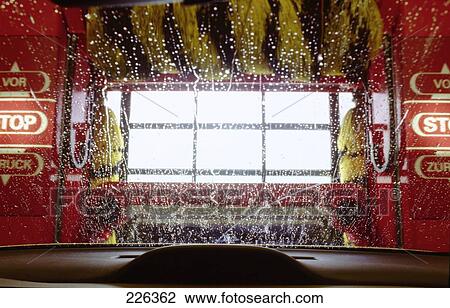 Stock Image - Low angle view of water droplets on windshield . Fotosearch